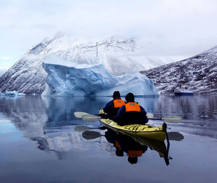 Kayaking past icebergs Antarctica