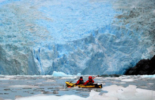 Kayaking by glacier front